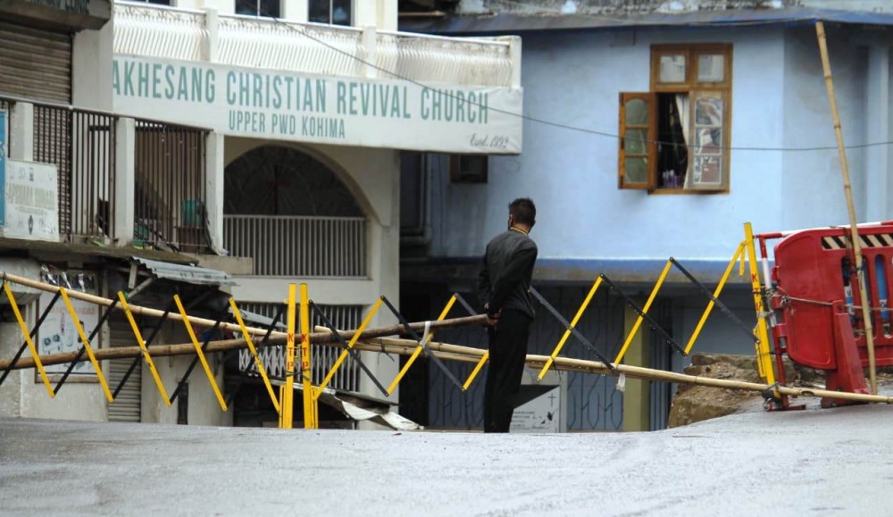 A man looks on near barricades put up in an area in Kohima Town. (Morung Photo)